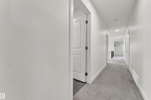Hallway featuring light gray carpeting, white baseboards, and recessed lighting - 22534 98A Avenue, Edmonton, AB - Indoor Photo Showing Other Room