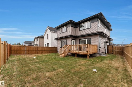 Fully fenced backyard featuring a spacious wooden deck with stairs to the lawn - 22534 98A Avenue, Edmonton, AB - Outdoor With Deck Patio Veranda