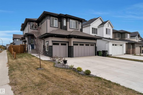 Contemporary two-story residence featuring a two-car garage, dark gray siding, and stone accents - 22534 98A Avenue, Edmonton, AB - Outdoor