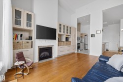 High ceilings complement the wood-finish flooring throughout this living area - 