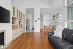 Open-concept living area with wood-finish flooring - 
