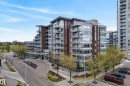 Modern multi-story building featuring brick and glass facades, multiple balconies with glass railings, a covered entry, and a paved driveway - 808 2612 109 Street, Edmonton, AB  - Outdoor With Facade 