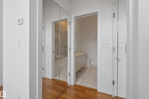 Hallway with wood-finish flooring, white walls, and bright overhead lighting - 808 2612 109 Street, Edmonton, AB - Indoor Photo Showing Other Room