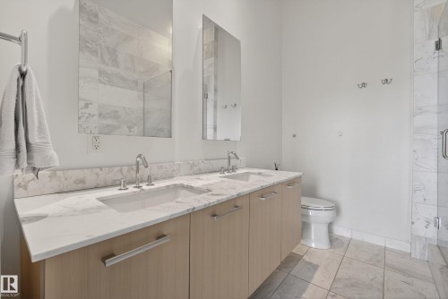 Double vanity with undermount sinks, stone countertops, and light wood-finish cabinetry - 808 2612 109 Street, Edmonton, AB - Indoor Photo Showing Bathroom