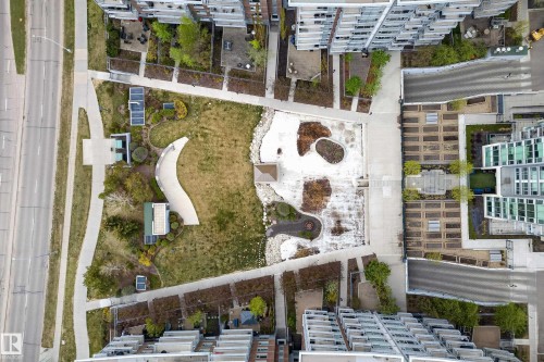 Centrally located green space featuring walking paths, structured planters, and integrated seating areas, surrounded by multi-story residential buildings - 808 2612 109 Street, Edmonton, AB - Outdoor
