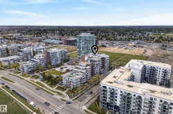Aerial perspective showcasing a contemporary multi-story building within an urban residential development - 