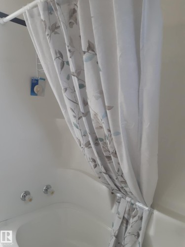 White drop-in bathtub featuring chrome fixtures - 3809 112 Avenue, Edmonton, AB - Indoor Photo Showing Bathroom