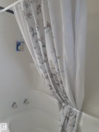 White drop-in bathtub featuring chrome fixtures - 