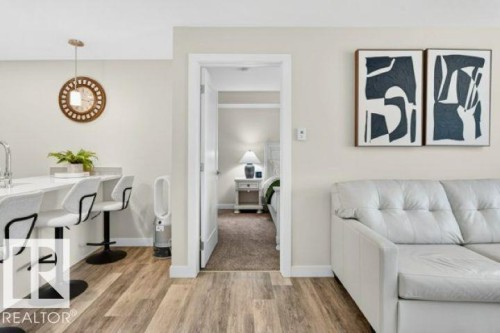 Open concept living area with wood-finish flooring - 209 1029 173 Stnw, Edmonton, AB - Indoor