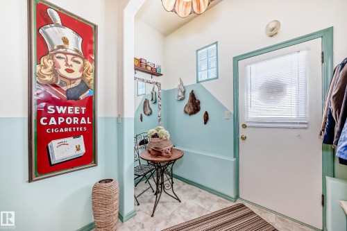 Entryway featuring a white door with an integrated window blind, light blue and white two-tone wall paint, and a decorative upper window - 11309 115 Street, Edmonton, AB - Indoor Photo Showing Other Room