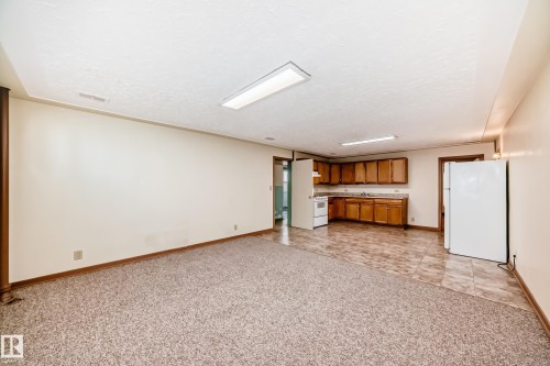 Spacious open-concept room featuring a functional kitchen area with wood cabinetry and appliances - 11309 115 Street, Edmonton, AB - Indoor Photo Showing Other Room