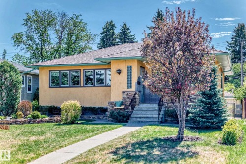 Stucco exterior with stone accents and a covered entryway - 11309 115 Street, Edmonton, AB - Outdoor