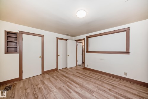 Room featuring wood-finish flooring, white walls, and dark wood trim - 11309 115 Street, Edmonton, AB - Indoor Photo Showing Other Room