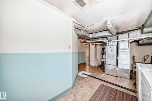 Utility room with exposed ductwork, furnace, and water heater - 11309 115 Street, Edmonton, AB - Indoor