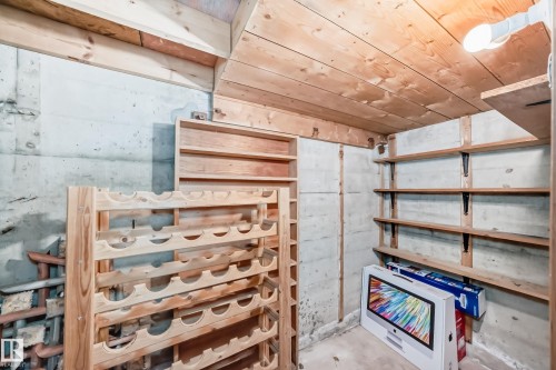 Concrete walls featuring extensive wood shelving and a wood-finish ceiling - 11309 115 Street, Edmonton, AB - Indoor