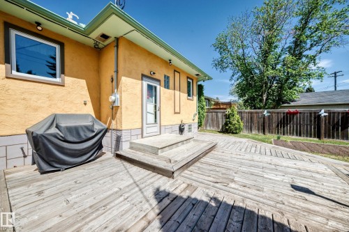 Expansive outdoor deck featuring wood planks and an integrated ramp - 11309 115 Street, Edmonton, AB - Outdoor With Deck Patio Veranda With Exterior