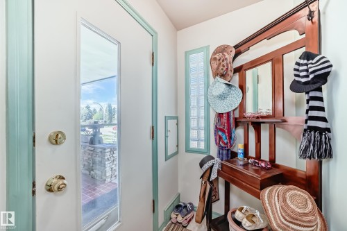 Entryway featuring a white door with a windowpane, brass hardware, and a light blue trim - 11309 115 Street, Edmonton, AB - Indoor