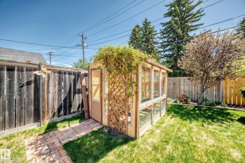 Garden shed featuring wood construction, multiple window panes, and an attached trellis - 11309 115 Street, Edmonton, AB - Outdoor