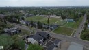 Aerial perspective showcasing a residential area bordered by mature trees and paved roadways - 14039 104 Avenue Nw, Edmonton, AB 