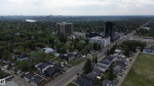 Aerial perspective showcasing a mixed-use urban landscape with established residential areas and contemporary high-rise developments - 14039 104 Avenue Nw, Edmonton, AB 
