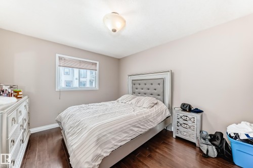 Bedroom featuring dark wood-finish flooring and light-toned walls - 9110 180A Avenue, Edmonton, AB - Indoor Photo Showing Bedroom