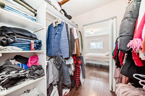 Walk-in closet featuring white shelving and hanging rods - 9110 180A Avenue, Edmonton, AB - Indoor With Storage