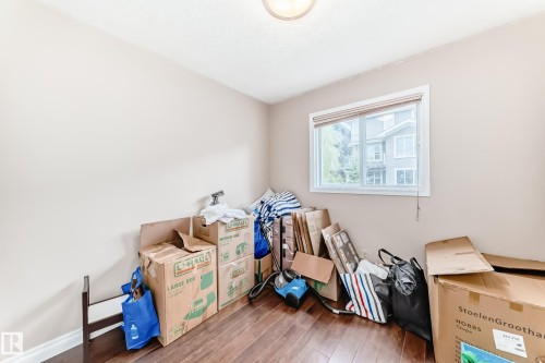 Room with wood-finish flooring, neutral wall paint, and a white-framed window - 9110 180A Avenue, Edmonton, AB - Indoor