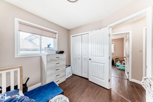 Interior room featuring wood-finish flooring, a white window frame, and neutral wall paint - 9110 180A Avenue, Edmonton, AB - Indoor Photo Showing Bedroom