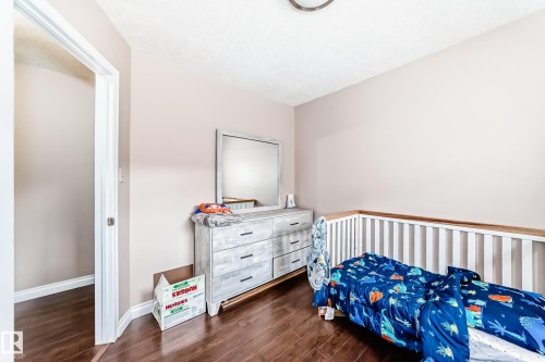 Hardwood-finish flooring extends throughout this room, complementing the light-toned walls - 9110 180A Avenue, Edmonton, AB - Indoor Photo Showing Bedroom