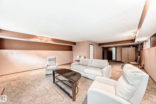 Expansive lower-level space featuring textured wall-to-wall carpeting and neutral-toned walls - 9110 180A Avenue, Edmonton, AB - Indoor
