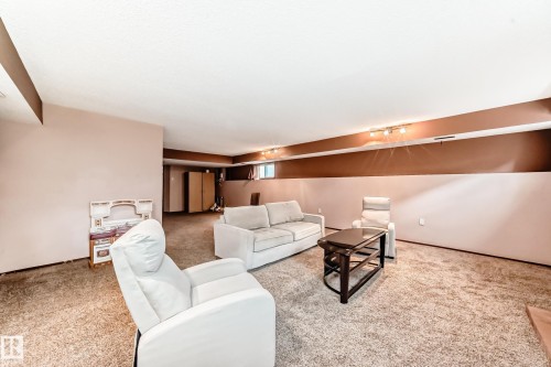 Spacious finished basement with track lighting and two-tone wall paint - 9110 180A Avenue, Edmonton, AB - Indoor Photo Showing Other Room