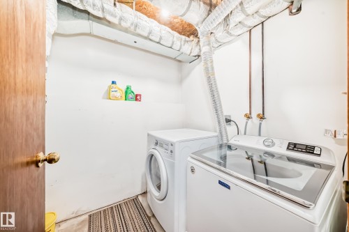 Dedicated laundry area featuring exposed ductwork and utility connections - 9110 180A Avenue, Edmonton, AB - Indoor Photo Showing Laundry Room