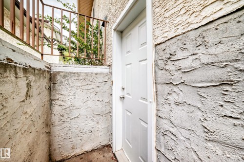 White paneled exterior door with a silver handle - 9110 180A Avenue, Edmonton, AB - 
