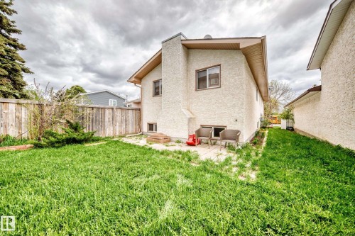 Exterior stucco finish with a pitched roofline, featuring a ground-level patio area - 9110 180A Avenue, Edmonton, AB - Outdoor