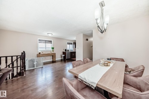 Open concept living area featuring dark wood-finish flooring, a contemporary chandelier, and recessed lighting - 9110 180A Avenue, Edmonton, AB - Indoor