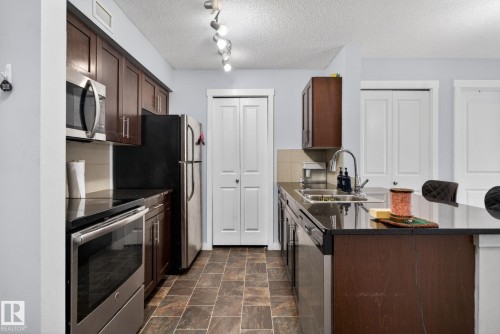 318 5810 Mullen Place, Edmonton, AB - Indoor Photo Showing Kitchen With Stainless Steel Kitchen