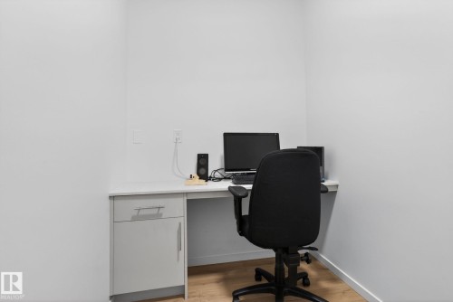 Dedicated workspace with built-in desk, white countertop, and integrated cabinetry - 7011 177 Avenue, Edmonton, AB - Indoor Photo Showing Office