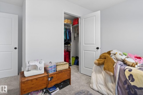 Bedroom featuring light gray walls, plush gray carpeting, and white interior doors with black hardware - 7011 177 Avenue, Edmonton, AB - Indoor