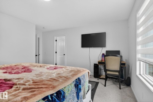 Bright interior space featuring light-toned carpeting and white walls - 7011 177 Avenue, Edmonton, AB - Indoor Photo Showing Bedroom
