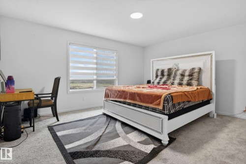 Bright room with a large window, recessed lighting, and light-toned carpet flooring - 7011 177 Avenue, Edmonton, AB - Indoor Photo Showing Bedroom
