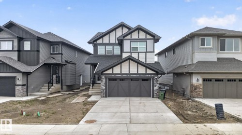 Contemporary two-story residence featuring a striking black and white facade with dark trim accents - 7011 177 Avenue, Edmonton, AB - Outdoor With Facade