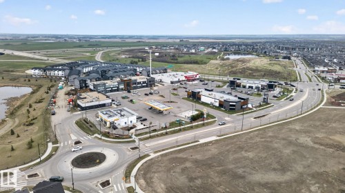 Aerial perspective showcasing a commercial development with multiple retail buildings, a gas station, and a traffic circle - 7011 177 Avenue, Edmonton, AB - Outdoor With View