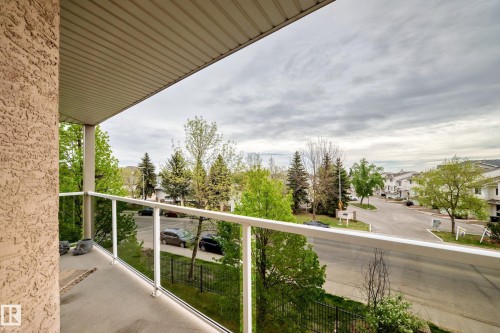 Private outdoor balcony with a glass railing system and a textured exterior wall - 331 9704 174 Street, Edmonton, AB - Outdoor With View