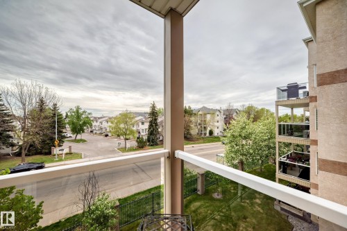 Private balcony featuring glass railings, a painted metal column, and an exterior light fixture - 331 9704 174 Street, Edmonton, AB - Outdoor