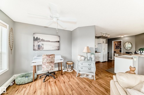 Open-concept living space featuring wood-finish flooring, a contemporary ceiling fan, and recessed lighting - 331 9704 174 Street, Edmonton, AB - Indoor