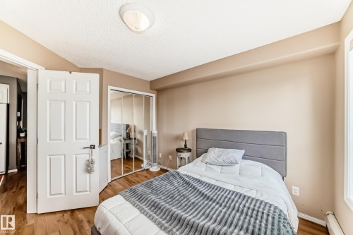 Neutral tone walls with wood-finish flooring - 331 9704 174 Street, Edmonton, AB - Indoor Photo Showing Bedroom