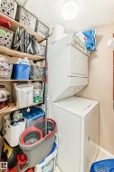 Dedicated utility area featuring a stackable washer and dryer - 