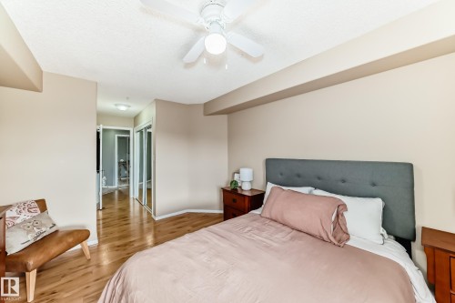 Bedroom featuring wood-finish flooring, a ceiling fan with integrated lighting, and a neutral wall palette - 331 9704 174 Street, Edmonton, AB - Indoor Photo Showing Bedroom