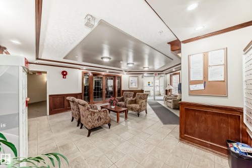 Inviting common area featuring patterned armchairs, a central coffee table, and light-toned tile flooring - 331 9704 174 Street, Edmonton, AB - Indoor Photo Showing Other Room