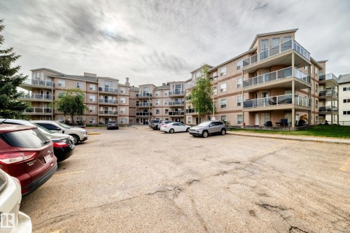 Multi-story building featuring tan siding and multiple balconies with glass railings - 331 9704 174 Street, Edmonton, AB - Outdoor